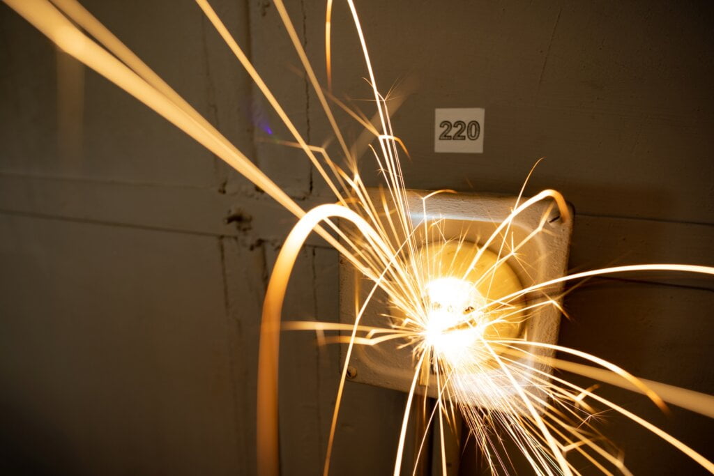 power outlet with 220 volt cable sparkles with electric sparks